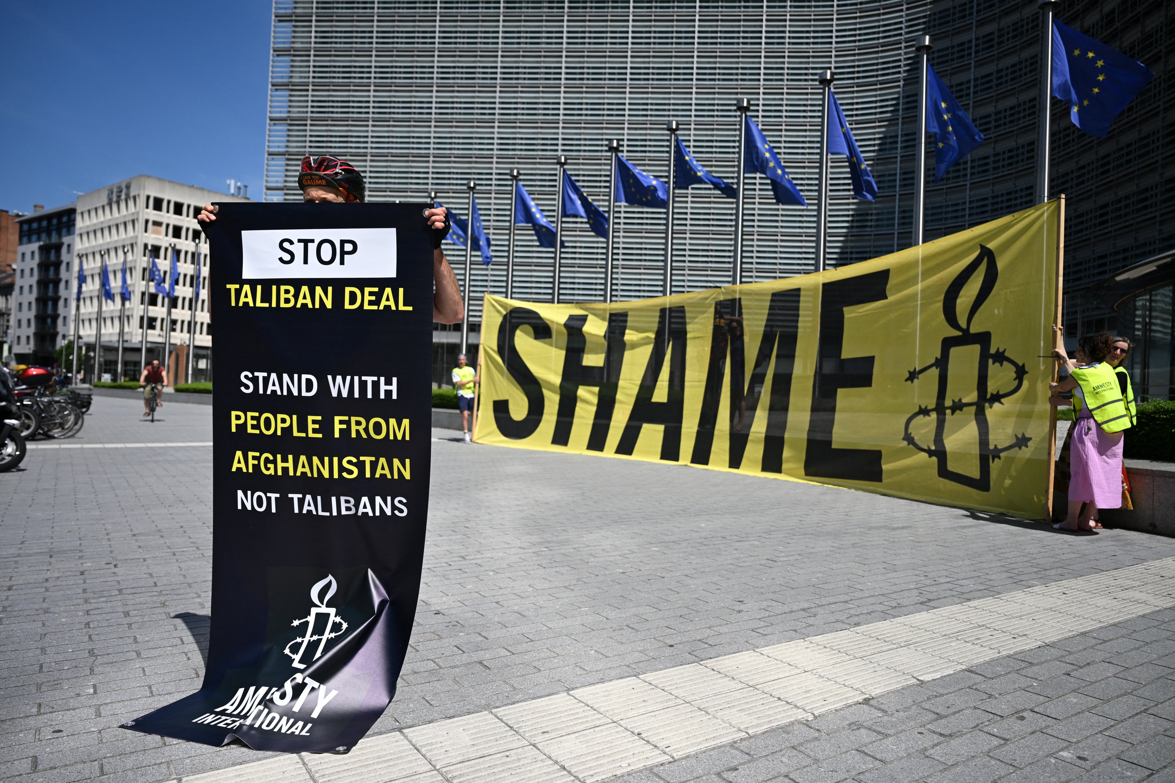 An activist at EU Commission headquarters protests against a meeting with a Taliban delegation in Brussels, Belgium, June 23, 2026.