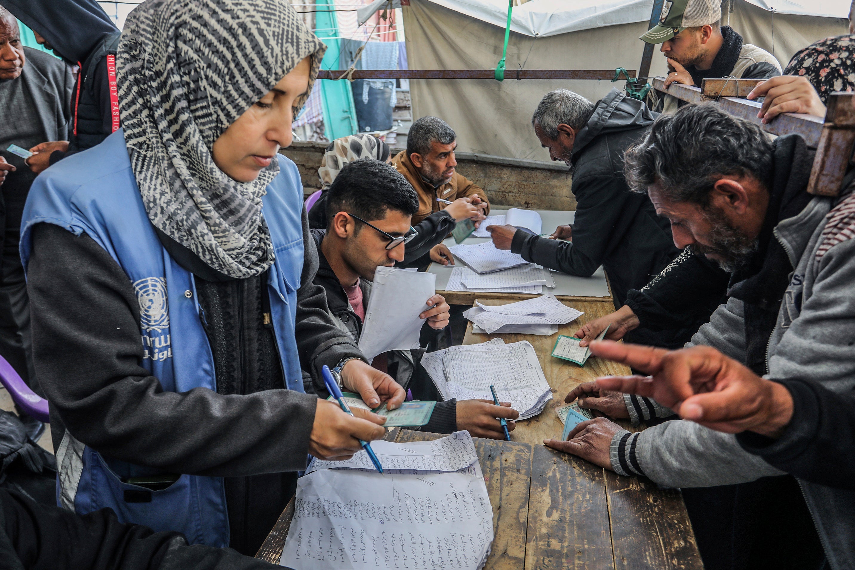 Palestinians receive humanitarian aid from the United Nations Relief and Works Agency for Palestine Refugees in the Near East (UNRWA) in Khan Younis, February 5, 2025. 
