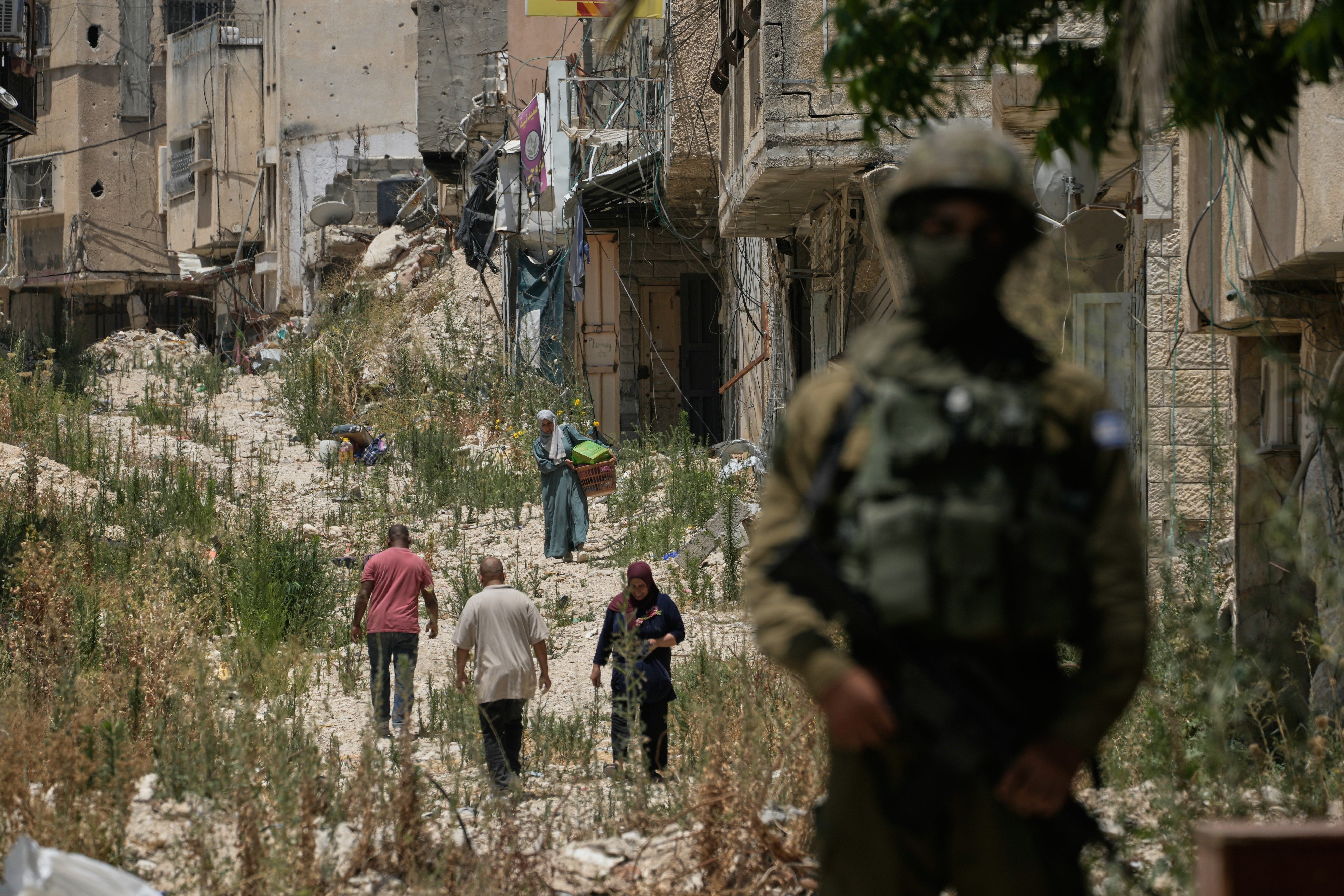 Des Palestiniens récupèrent leurs effets personnels dans leurs maisons évacuées après que l'armée israélienne a délivré plusieurs autorisations d'accès de courte durée aux habitants du camp de réfugiés de Tulkarem, situé en Cisjordanie occupée, le 17 juin 2026.