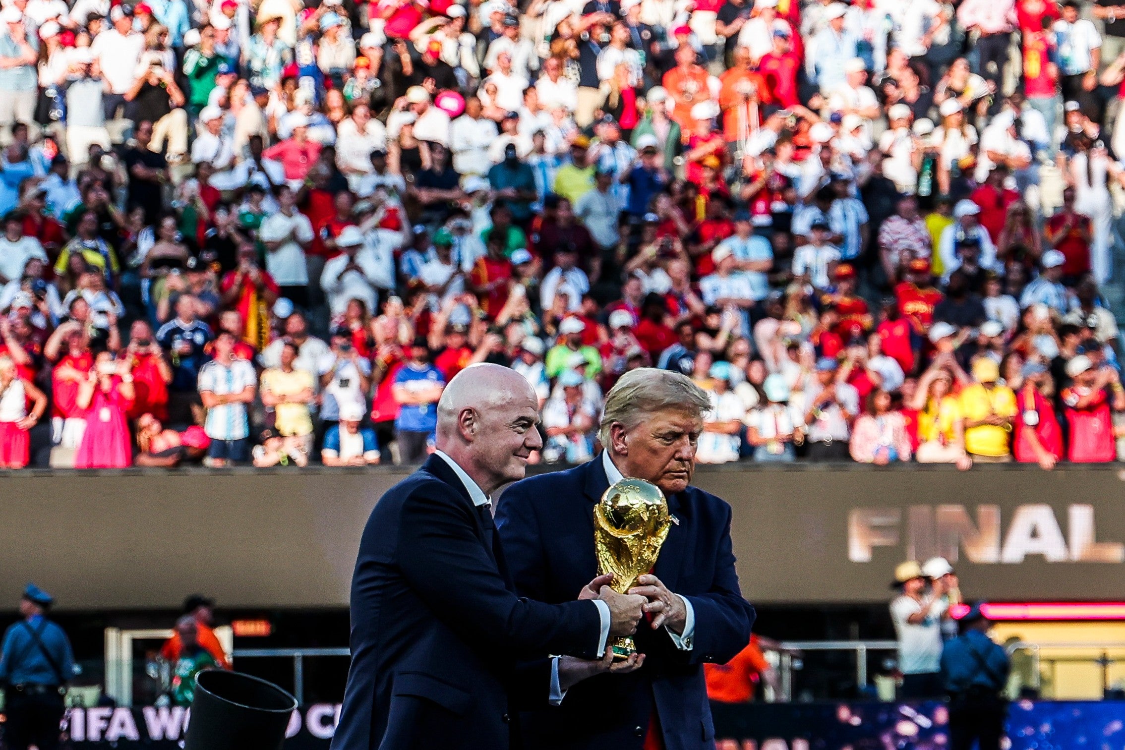 Infantino and Trump jointly holding the World Cup Trophy