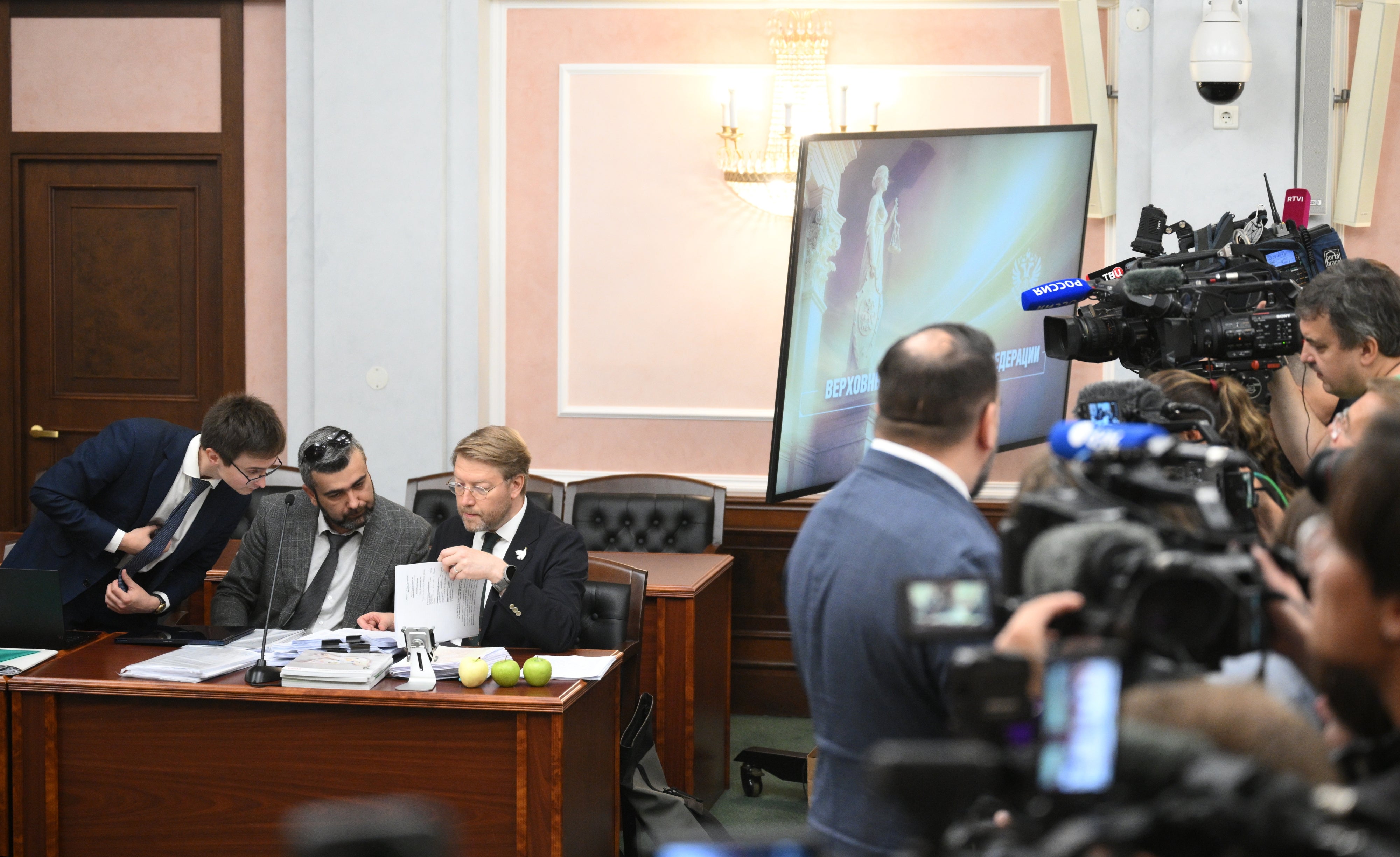 Lawyer Vitaly Iskakov (left), attorney Gadzhi Aliyev (center) and Chairman of the Yabloko political party, Nikolai Rybakov, attend a hearing on a lawsuit filed by the Rodina (Motherland) party seeking to bar the Yabloko party from the State Duma election, at the Russian Supreme Court in Moscow, Russia, August 10, 2026.