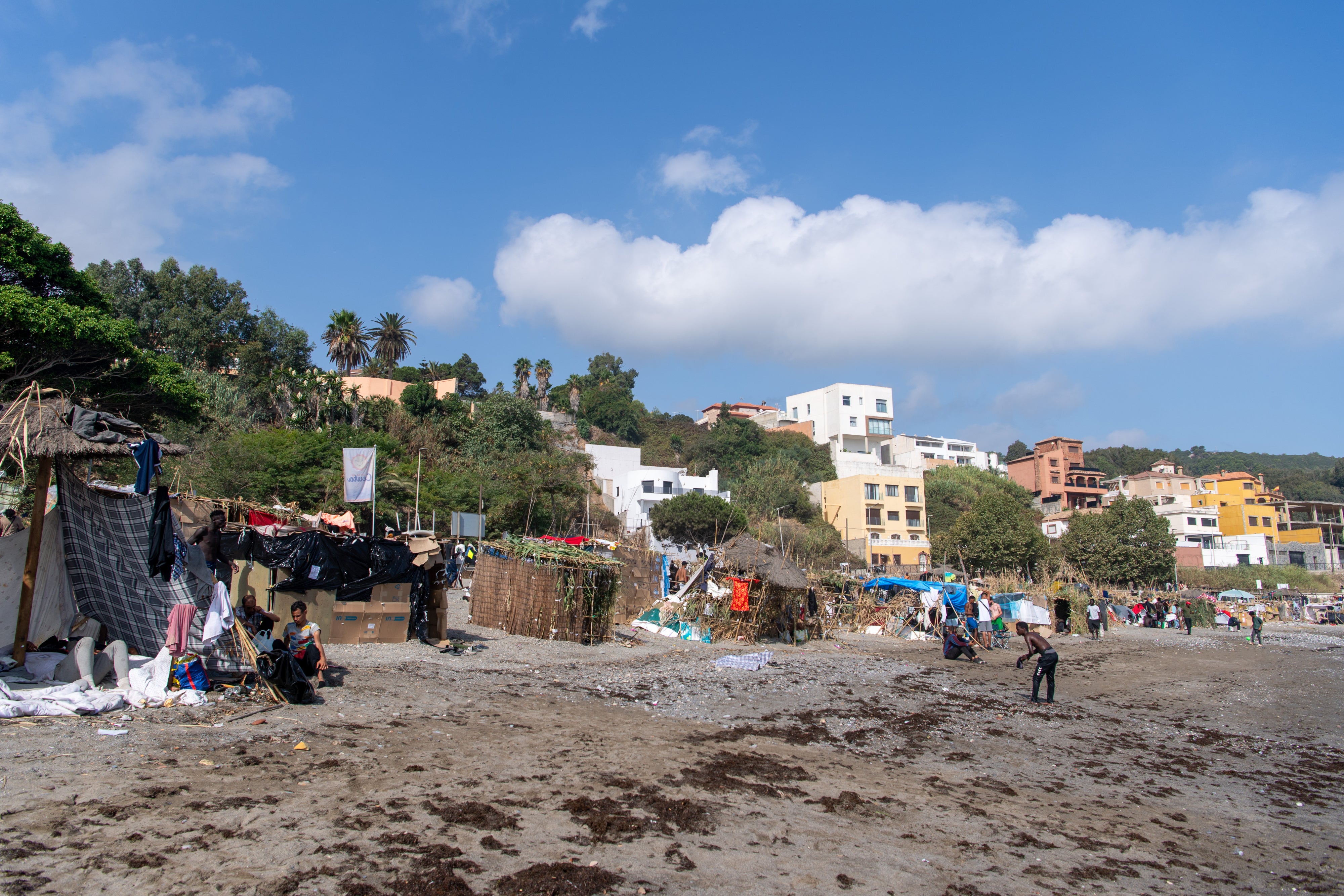 Men on the Trampolín beach, Ceuta, where more than a thousand migrants and asylum seekers camped in makeshift huts