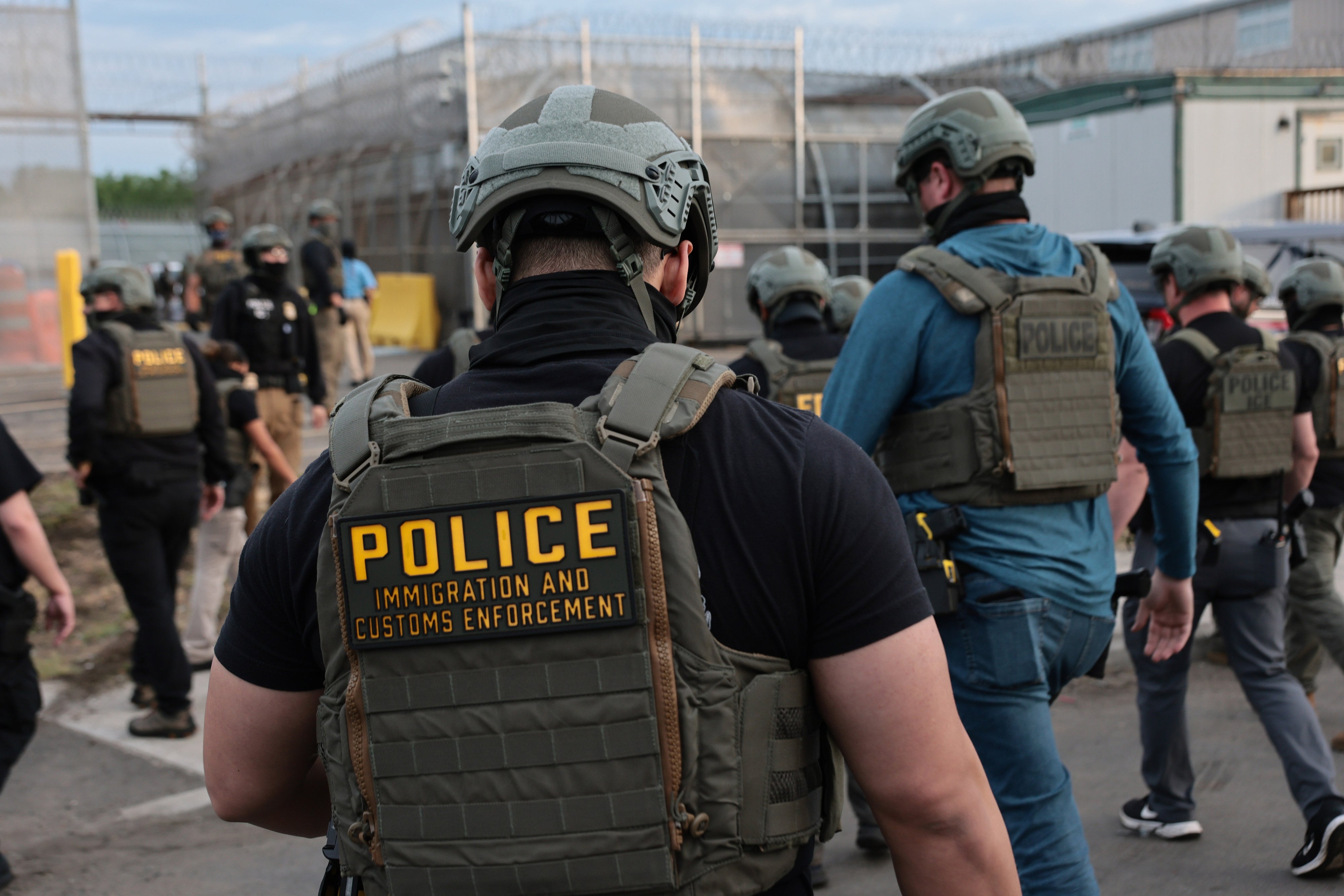 US Immigration and Customs Enforcement (ICE) agents block protesters as cars exit Delaney Hall, which is being used as an ICE detention center, on May 27, 2026 in Newark, New Jersey.