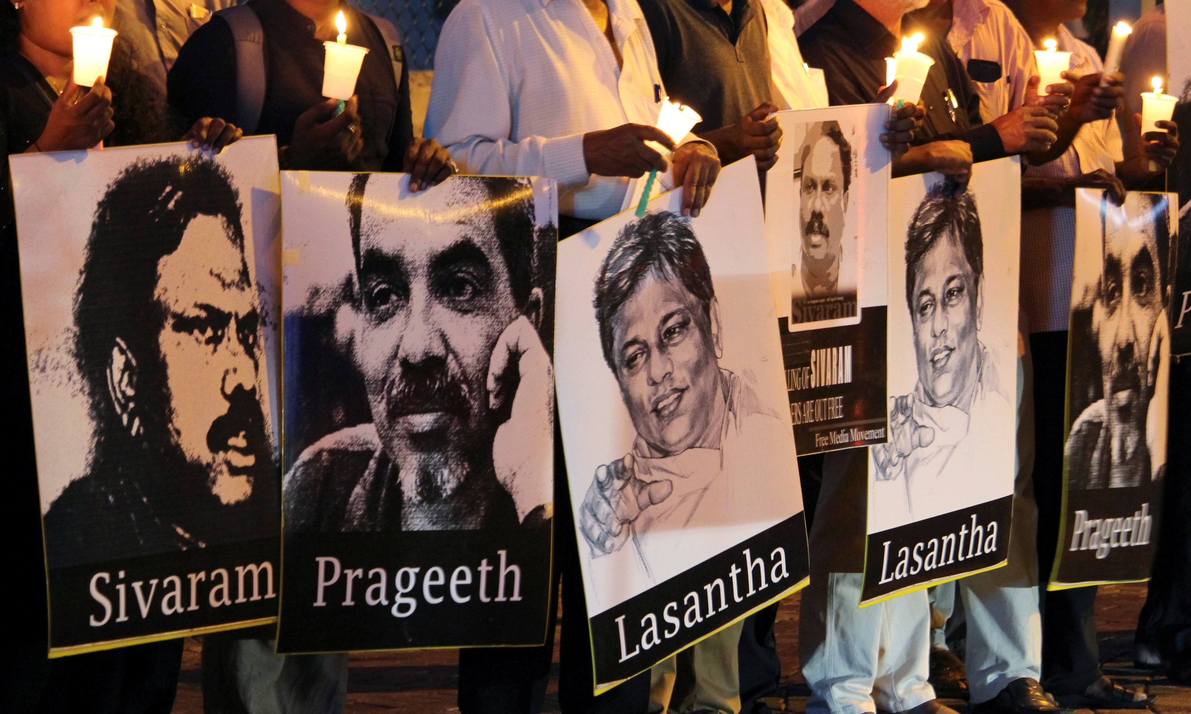 Members of the Sri Lankan media hold placards of journalists at the “Black January” vigil to commemorate journalists who have disappeared, in Colombo, Sri Lanka, January 28, 2020. 