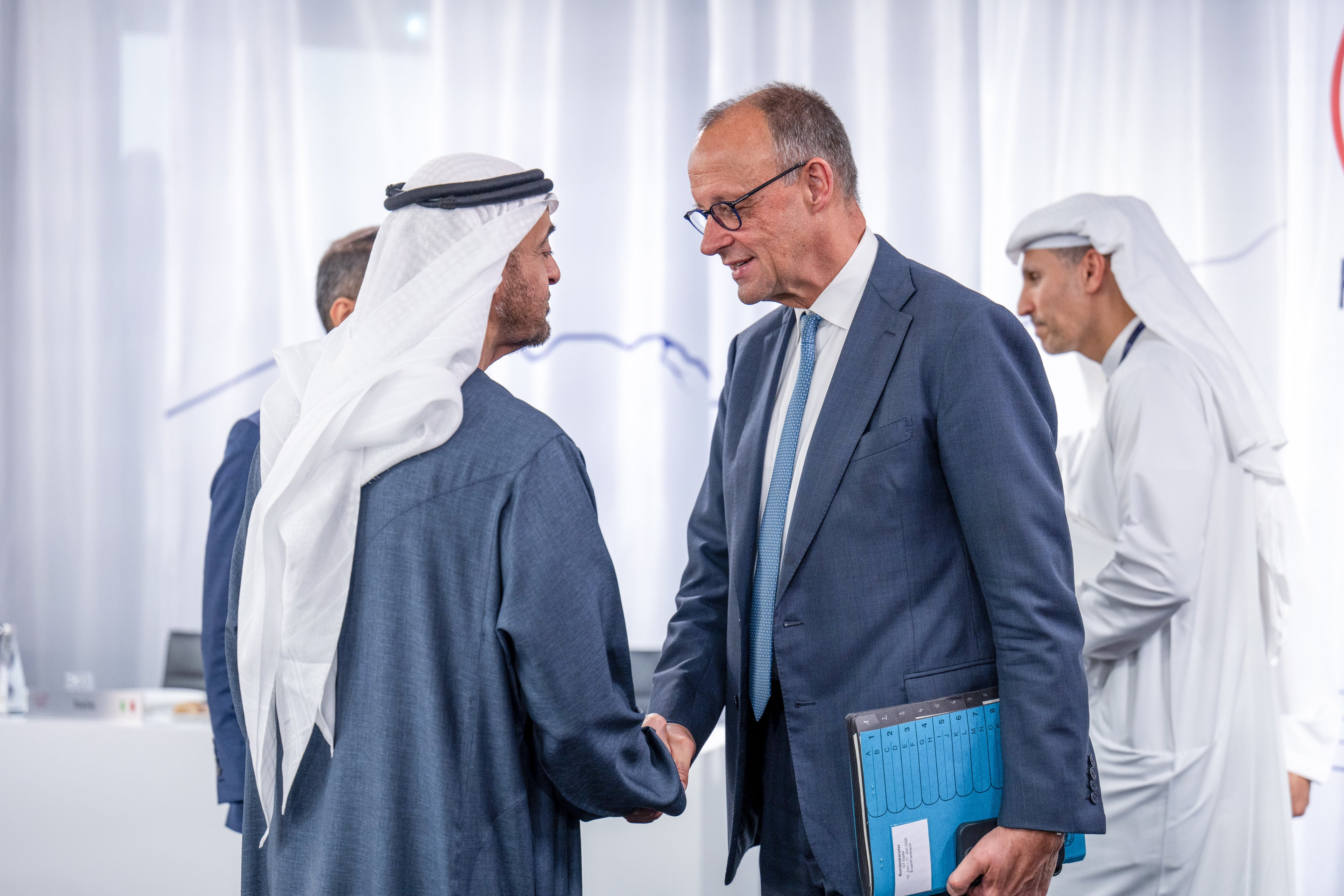 Germany's Chancellor Friedrich Merz, UAE's President Sheikh Mohamed bin Zayed al-Nahyan shake hands.