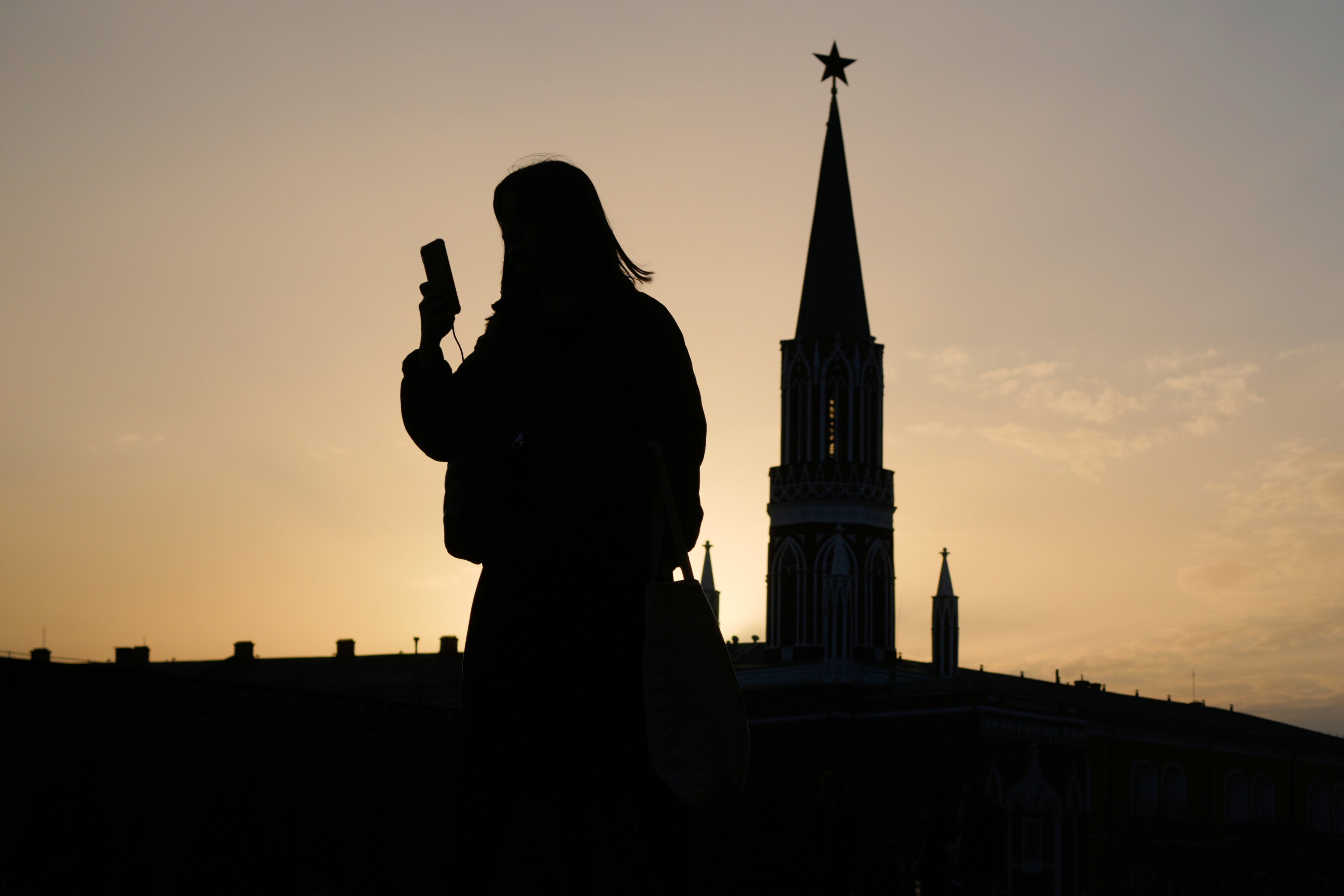  A person checks their phone in the Red Square in Moscow, Russia, March 31, 2026.
