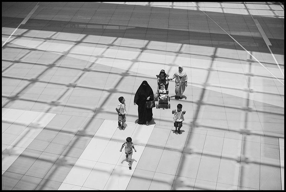 A female employer and her children are accompanied by their domestic worker, back right, as they walk through The Avenues, an indoor luxury shopping center in Kuwait City. 