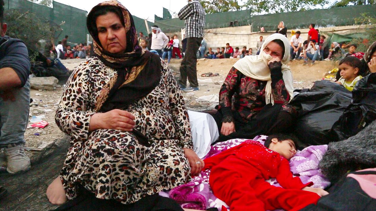 Screenshot taken from video footage of an Afghan woman with her 15-year-old daughter who has multiple disabilities on the ground outside the Moria registration camp on the Greek island of Lesbos. October 5, 2015.