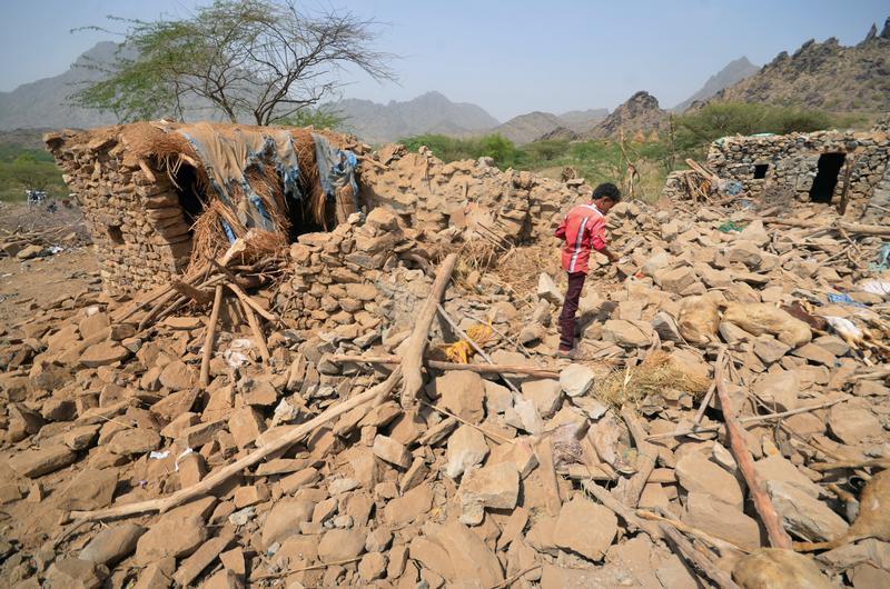 A boy walks on the rubble of houses destroyed by Saudi-led air strikes in Khamis Bani-Saad district of the western province of al-Mahweet, Yemen, October 27, 2016.