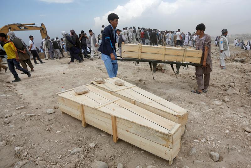 Afghan men carry empty coffins for the victims of a suicide attack in Kabul, Afghanistan July 24, 2016.