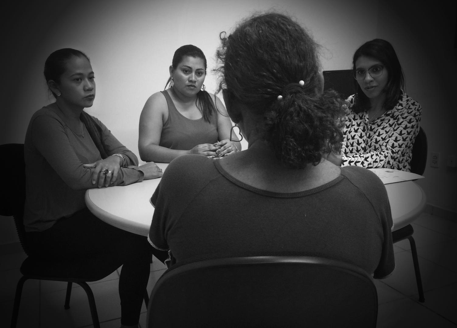 Staff from the Humanitarian Support Center for Women (CHAME, in Portuguese) listen to a woman in Boa Vista, Roraima, on February 17, 2017. CHAME provides legal, psychological, and social support to survivors of domestic violence. 