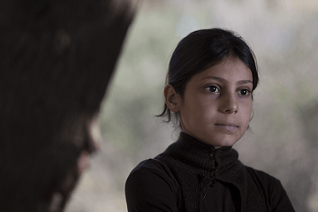 Bara’a, 10, teaching younger children in her informal refugee camp in Mount Lebanon what she remembered from her first grade class in Syria.