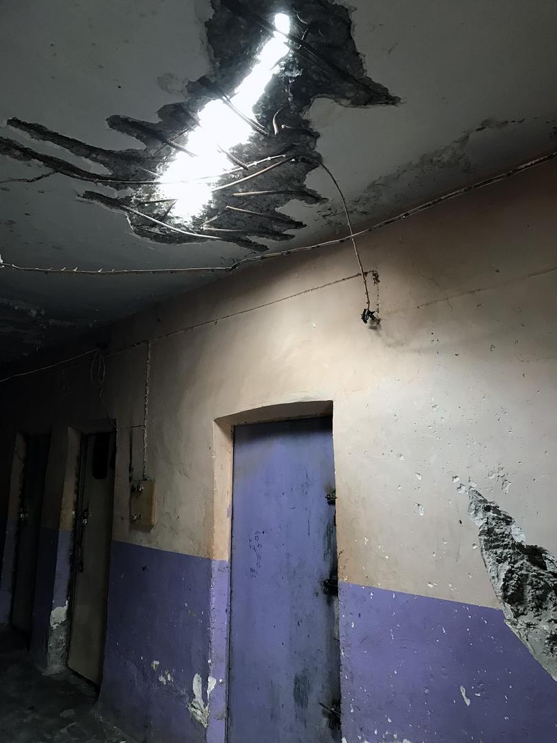 A hole in the ceiling of the second prison house, from a projectile that hit the building while the area was still under ISIS-control. Staff said the prison, holding 270 detainees, was structurally unsound and could collapse at any point.