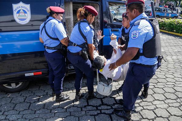 A person is arrested by riot police during a protest against the government of President Daniel Ortega in Managua