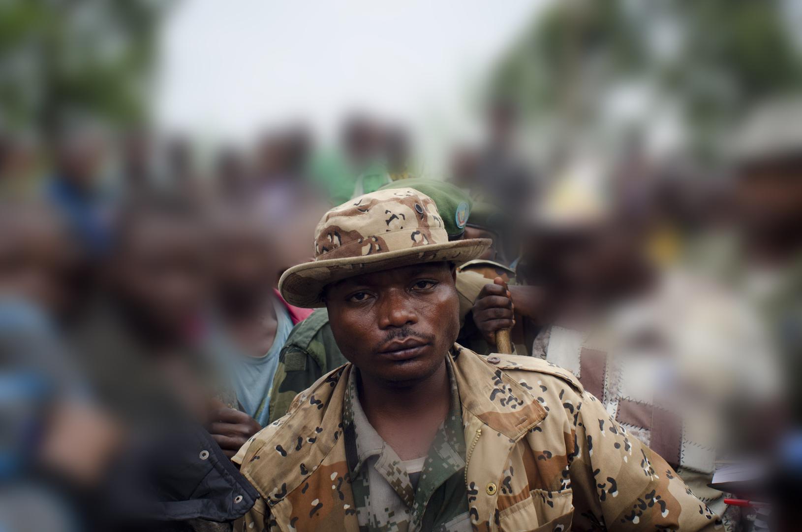 Marcel Habarugira (center) poses for a photograph in Ngululu, 80 kilometers northwest of Goma, Democratic Republic of Congo, 2012.