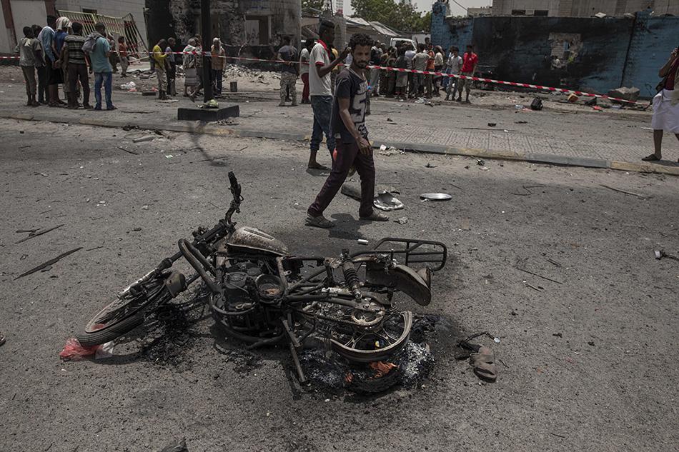 Civilians gather at the site of a deadly attack in Aden, Yemen