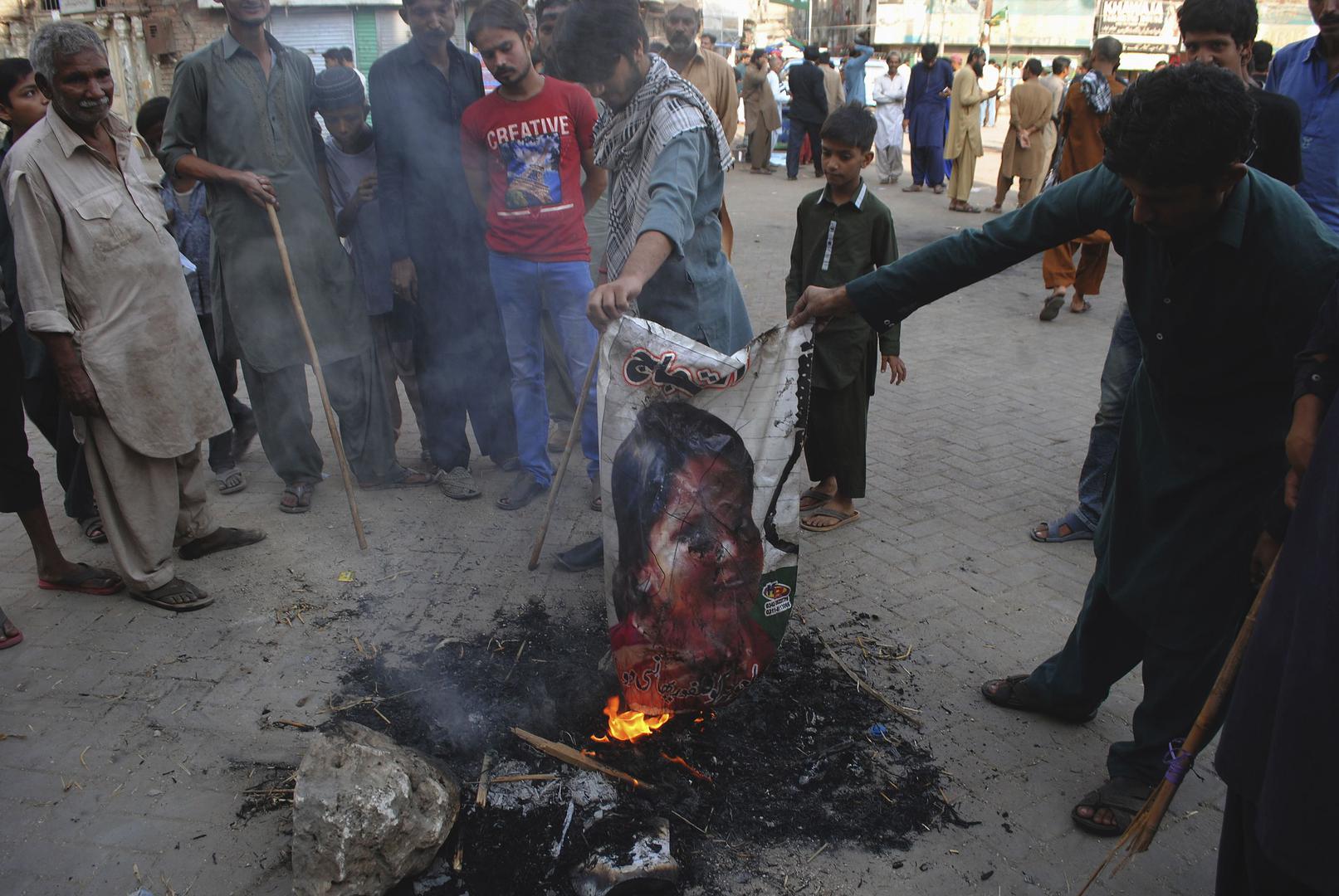Protesters burn a poster of Aasia Bibi after the Supreme Court overturned her conviction under the blasphemy law, Hyderabad, Pakistan, November 1, 2018.