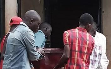 Relatives of Brian Wasswa carry his coffin during his funeral on October 6, 2019. 