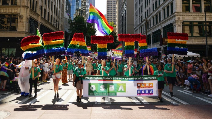 Marchers with the Greater Seattle Business Association, Washington State's LGBTQ+ and allied chamber of commerce, during the annual Seattle Pride Parade, June 25, 2023.