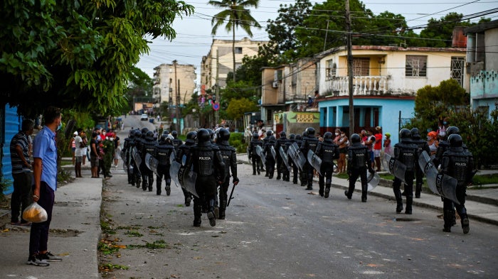 Riot police walk the streets after a demonstration against the government of President Miguel Diaz-Canel in Arroyo Naranjo Municipality, Havana, Cuba, on July 12, 2021.