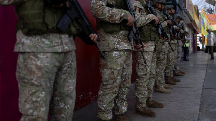 Military officers patrol a street after the government declared a state of emergency in Lima on October 22, 2025.