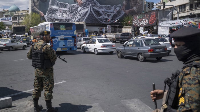 Two members of Iran’s security forces stand guard in downtown Tehran, Iran, on April 8, 2026.