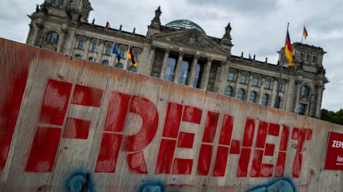 Graffiti on a wooden fence in front of the Reichstag building in Berlin, Germany reads "Freedom," on May 19, 2025.