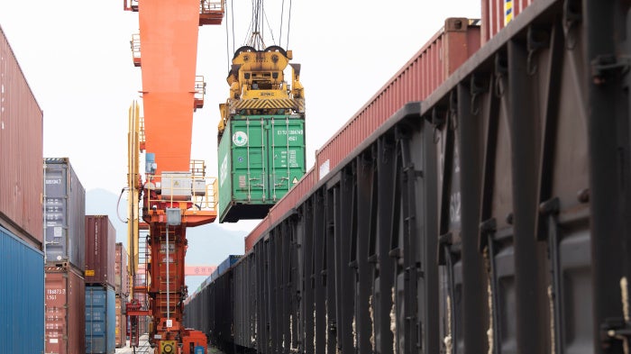 Containers are loaded onto a China-Europe Railway Express (Yiwu-Xinjiang-Europe) market procurement train at the Jinhua Yiwu Railway West Station in Jinhua, China, on June 8, 2026.