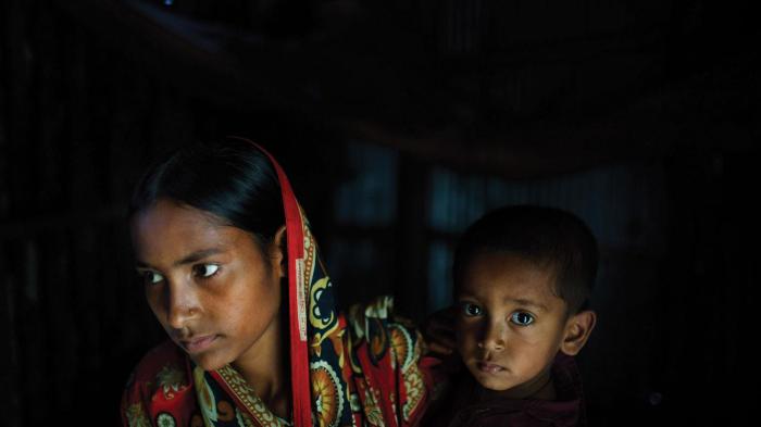 Belkis, 15 years old, holds her one-year-old son in the house where she lives with her mother, two sisters, and one brother. Belkis was married when she was 13 years old to a man who threatened to commit suicide if the family didn’t agree to the marriage.