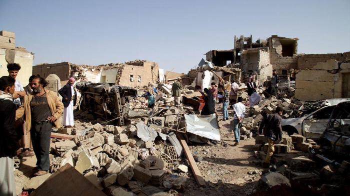 Residents sifting through the rubble of homes destroyed in an airstrike three days prior in Yareem town. The strike killed at least 16 civilians.