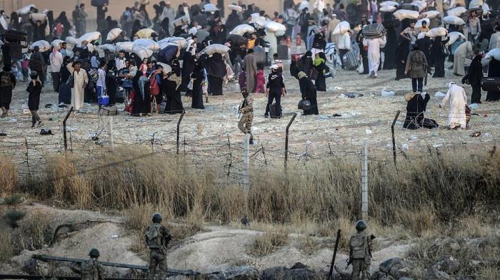 At Tal Abyad –Akçakale border crossing, in June 2015, Turkish border guards manning Turkey’s closed border watched ISIS fighters order displaced Syrian civilians back from the border.