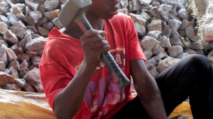 A 12-year-old boy crushes stones at Homase processing site, Amansie Central district, Ashanti Region, Ghana.