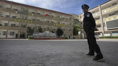 A security guard outside the Shangri-La Key School in Kardze Tibetan Autonomous Prefecture, Sichuan province, China, September 5, 2023. 
