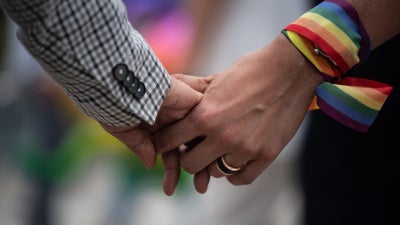 A same-sex couple hold hands during an event to raise awareness of gay rights in Hong Kong on May 25, 2019. 