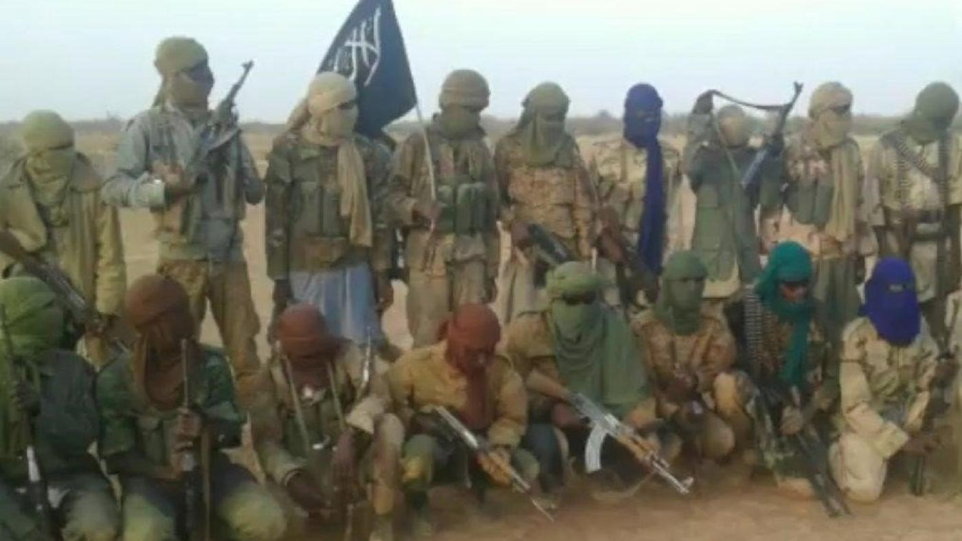 A group of armed men pose for a photo