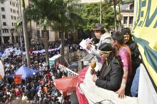 Indigenous leaders read a manifesto to a large crowd at a law school