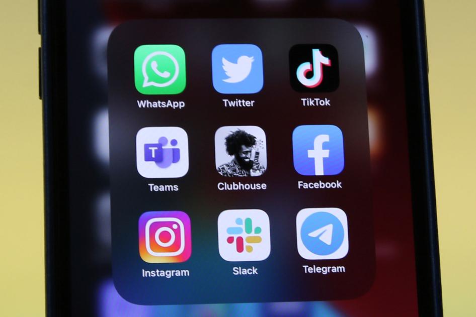 Logos of social media platforms including Clubhouse, center, are seen on an iPhone 12.