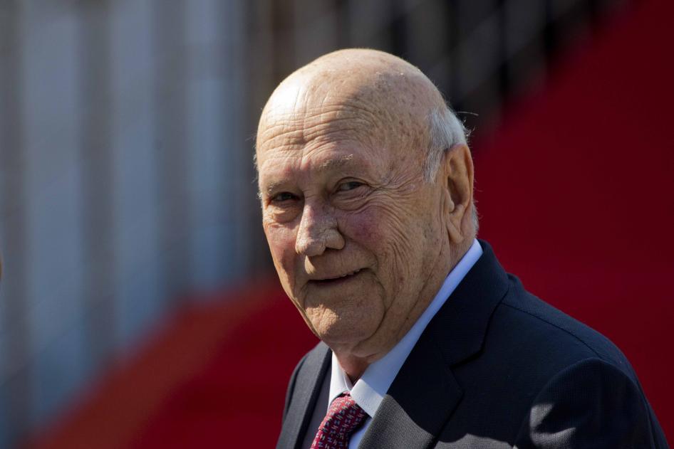 An elderly man smiles at the camera