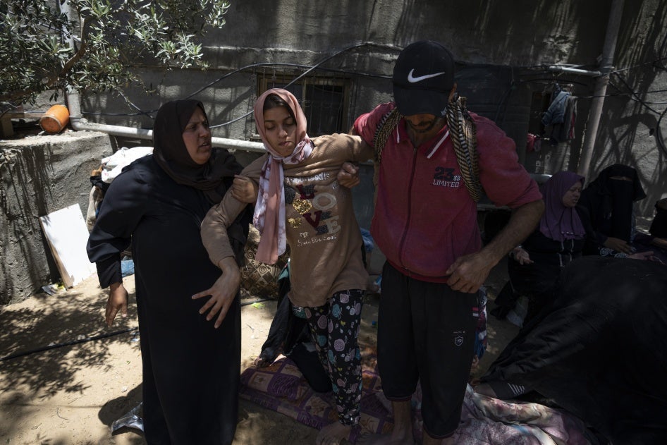 Haneen Nabhan, who has physical and intellectual disabilities, next to the ruins of her family’s home in the Jabaliya refugee camp in Gaza, which was destroyed in an Israeli airstrike on May 14, 2023. 