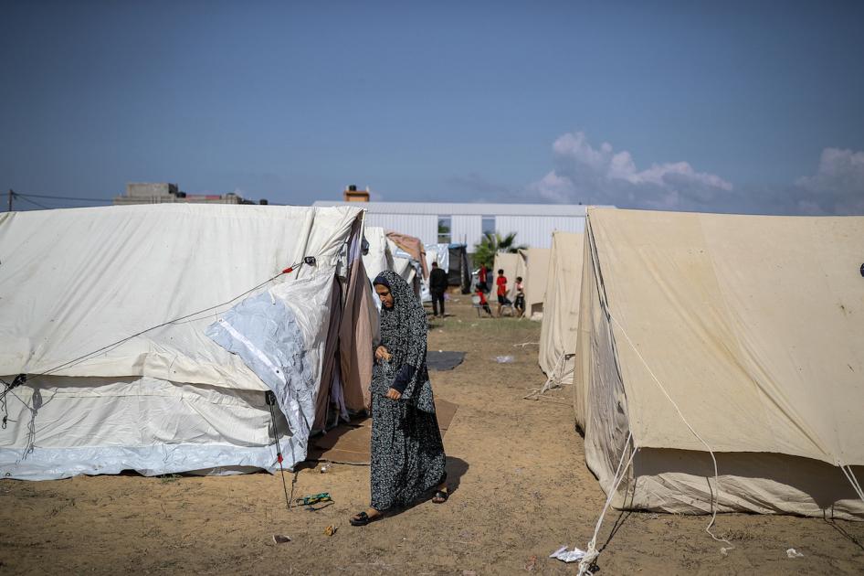 A girl walks around tents at a camp set up by the United Nations Relief and Works Agency for Palestine Refugees (UNRWA) for Palestinians who fled to the southern Gaza Strip, October 19, 2023. 