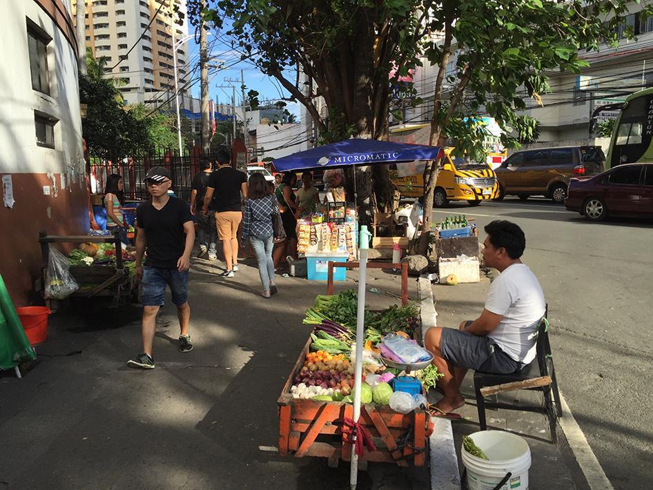 小贩在马尼拉维托克鲁兹道（Vito Cruz Street）摆摊，附近的菲律宾国际会议中心即将举办APEC首脑会议。政府为准备这场会议封锁道路，将使这些摊贩失业一周以上。菲国政府表示，清空首脑会议周边道路是为了维护安全和治安。2015年11月12日。