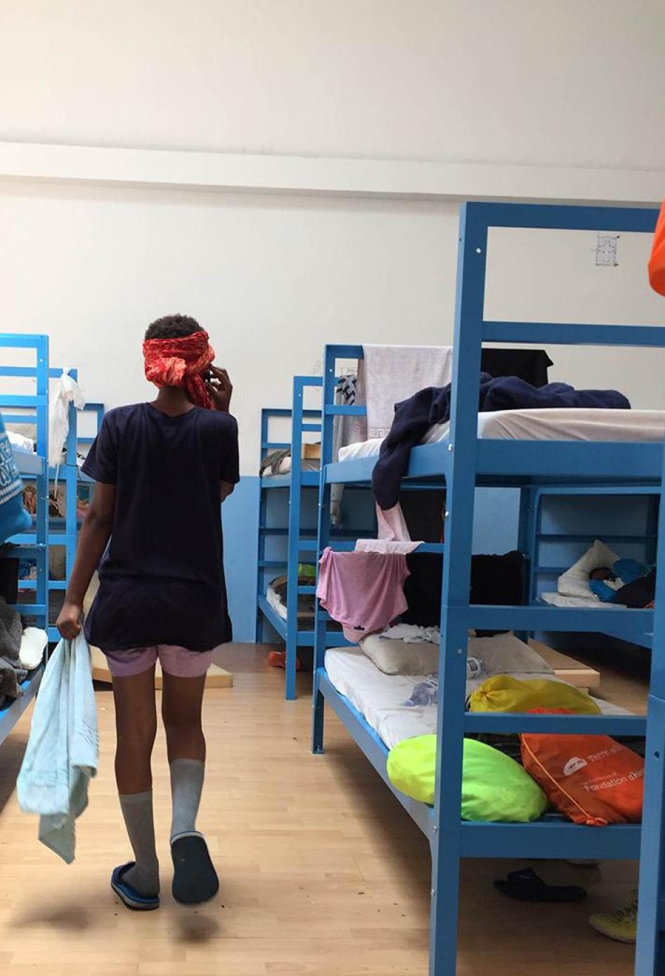 "Yodit," a 16-year-old girl from Eritrea, talks on the phone to her mother for the first time after her rescue at sea and arrival to Pozzallo hotspot, Sicily, Italy.