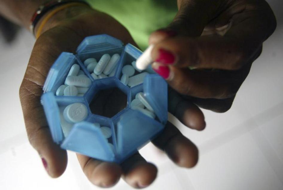 A woman who is infected with HIV prepares her medicines in a shelter house in Jayapura of the Indonesia Papua province November 27, 2008. 