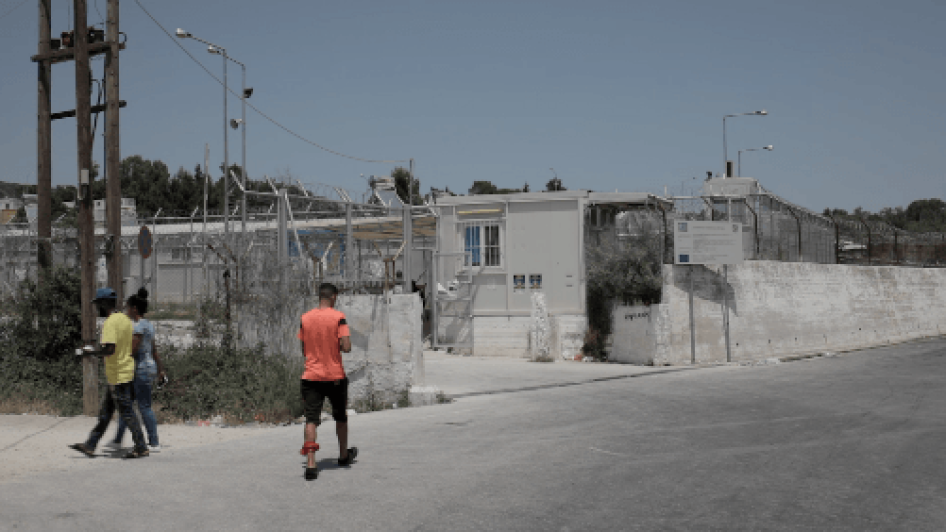 Entrance into the Moria hotspot in Lesbos, Greece, where children registered as adults are accommodated with unrelated adult single men, exposed to very poor living conditions, including overcrowding, inadequate sanitation, and frequent incidents of viole