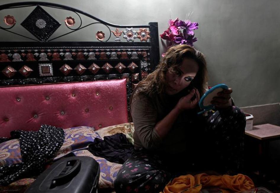 a member of the transgender community, applies make up as she prepares for Shakeela's party in Peshawar, Pakistan January 22, 2017.