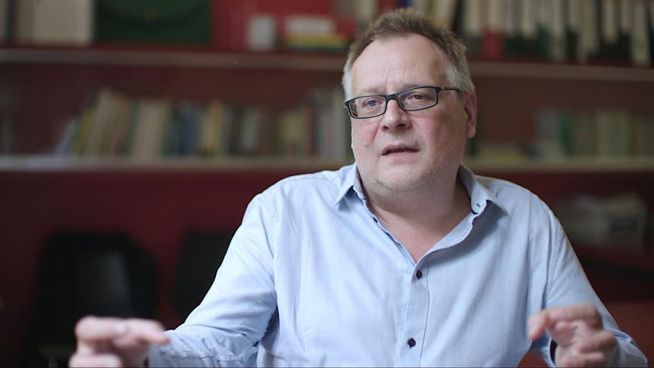 A man speaking in front of a camera
