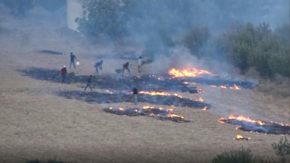 Des habitants tentent d'éteindre des incendies provoqués par une attaque à l'arme incendiaire dans l'ouest d'Idlib, Syrie, 30 juillet 2018.