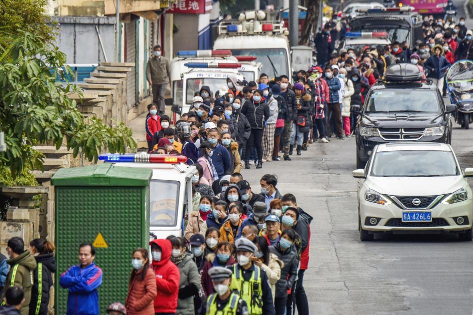 People line up to buy face masks from a medical supply company in Nanning, southern China's Guangxi Zhuang Autonomous Region. 