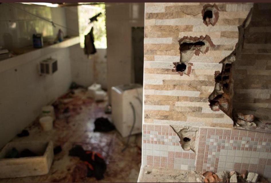 Bullet holes in the wall and blood on the floor of a house in the Fallet neighborhood in Rio de Janeiro after police killed nine men there on February 8, 2019.