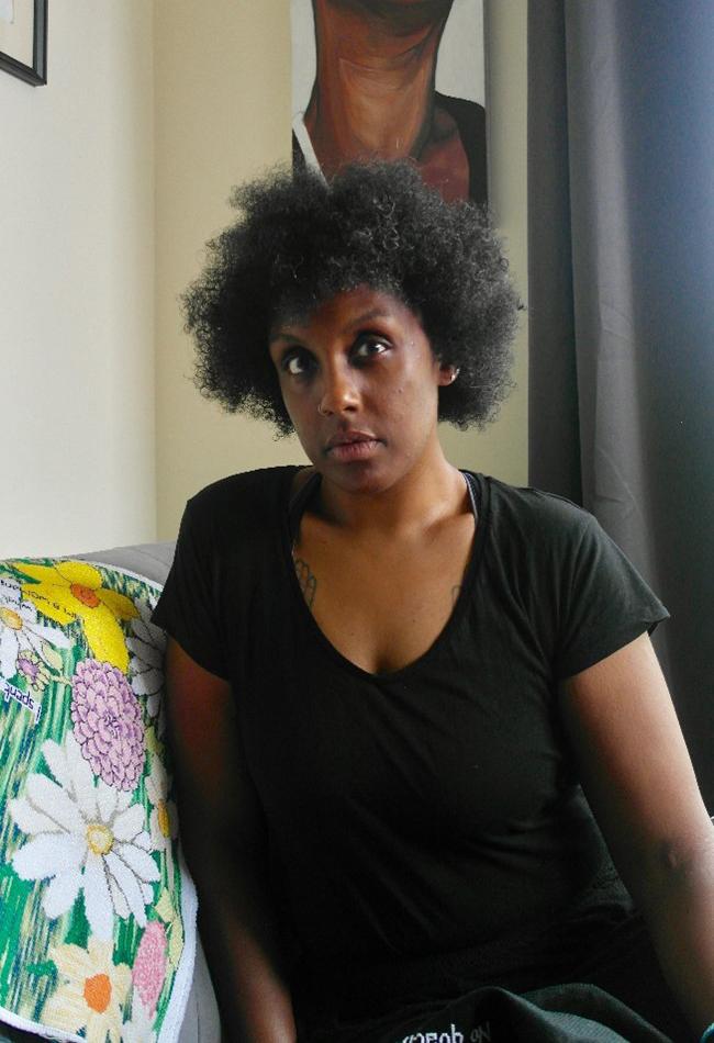 A woman in a black t-shirt poses for the camera